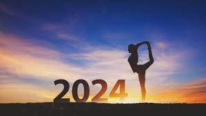 2024 written with someone doing dancer pose while standing on beautiful colourful sky